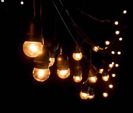 Garlands of lamps over dark texture