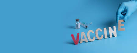 Word "VACCINE" with syringe and vaccine on blue background,Healthcare and vaccine Conceptの写真素材