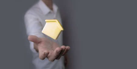 New home and house concept,businessman holding model houseの写真素材