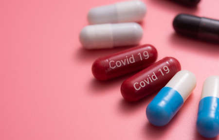 COVID-19 medicine, medicine for COVID-19, Capsule medicine, capsules pills,various capsule on a pink backgroundの写真素材