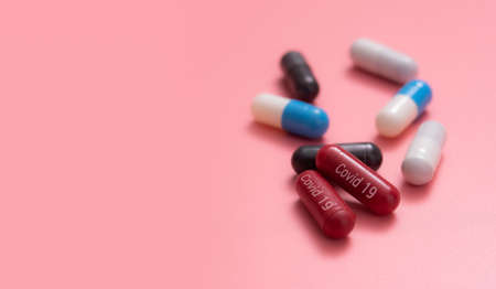 Multicolored pills,various capsule on a pink backgroundの写真素材