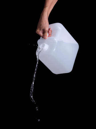 Water pouring from gallon container by handsの写真素材