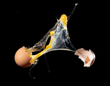 explosion of egg,exploding of egg on black backgroundの写真素材