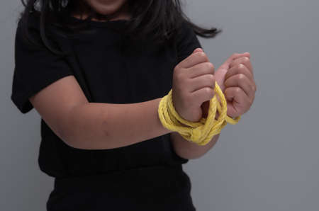 Child's hands tied with rope ,kidnapping conceptの写真素材