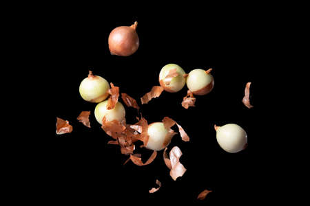 Levitation flying onion, isolated on black backgroundの写真素材