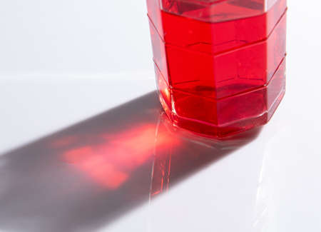 Shadow of soda water in glass with liquid,sunshine throughの写真素材