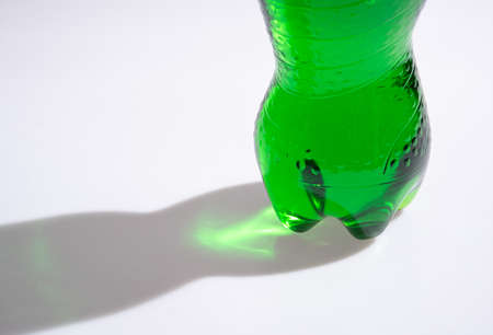 Shadow of bottle soft drink with liquid,sunshine throughの写真素材