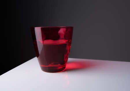 Red water glass over a black background.vintage glasswareの写真素材