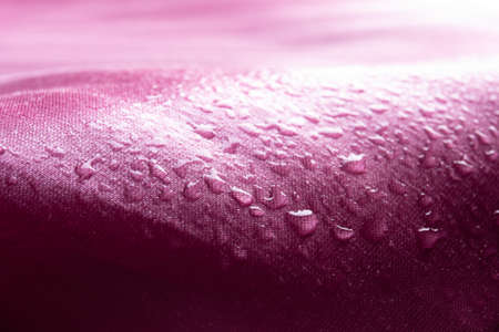 Water drops on pink waterproof fabric,Waterproof coating backgroundの写真素材