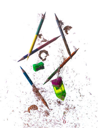 Flying colored pencils ; sharpened pencil and shavingsの写真素材