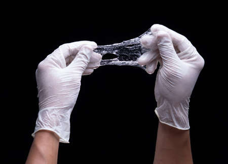 Test for sticky cosmetic lotion or gel against a black backgroundの写真素材