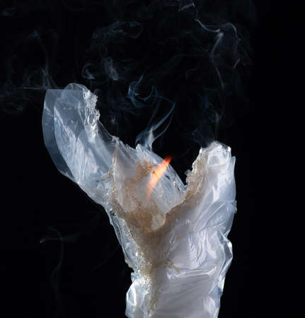 The fire is burning plastic bag on a dark background.