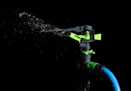 Water Springer Working on black background.の写真素材