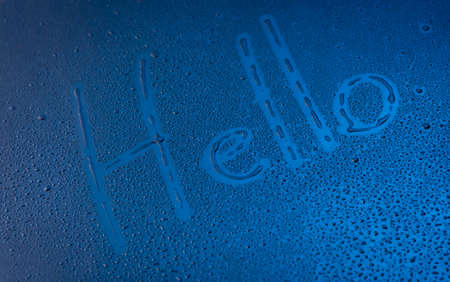 Word - Hello,Handwritten text on wet glass,Water drops on the window glassの写真素材