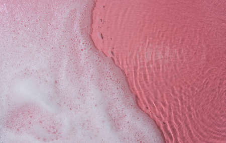 Foam bubbles abstract pink background,top viewの写真素材