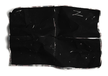 Crumpled black paper sheet isolated on white,Old book
