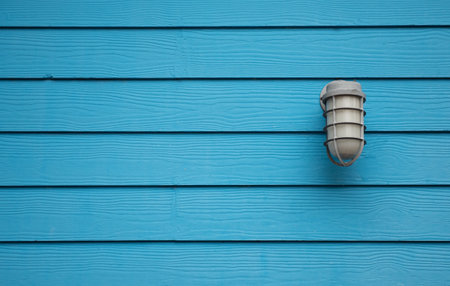 lamp on a blue wooden wall,Outside lighting.