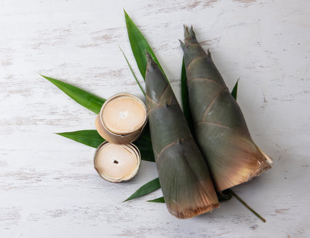 Raw Green Bamboo shoot for cooking food in thailand, on wooden table backgroundの写真素材