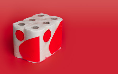Package of toliet paper with blank label for text against a red background.の写真素材