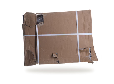 damaged cardboard parcel on white backgroundの写真素材