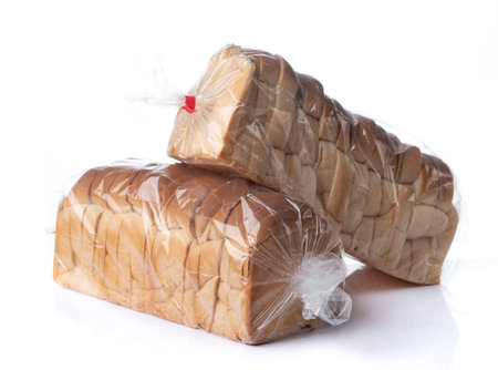 Sliced toast bread in plastic bag on a white backgroundの写真素材
