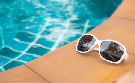 Sun glasses near swimming pool,summer travel conceptの写真素材