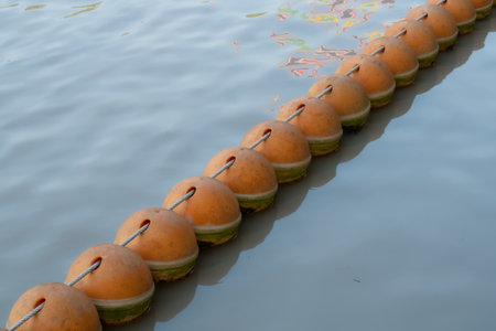 Red buoys on the water surface. Buoys warning of danger at riverの写真素材