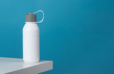 White sport plastic water bottle on a blue backgroundの写真素材