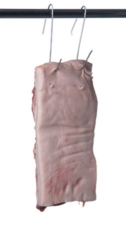 Belly pork meat hanging from the hook, isolated on white background.の写真素材