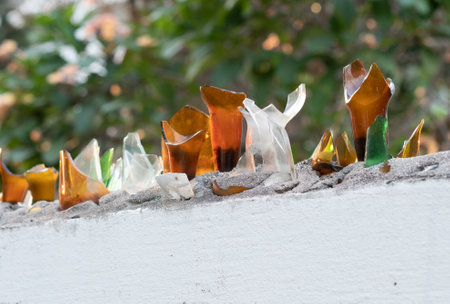 large security wall ,Broken Glass Bottles Covered Concrete Fences for Anti Climb Conceptの写真素材