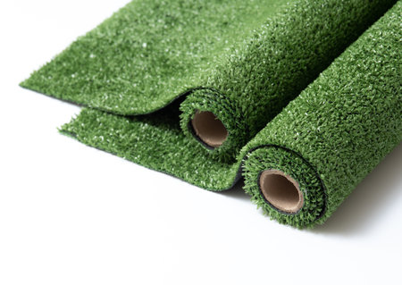 roll of artificial grass mat isolated on a white backgroundの写真素材