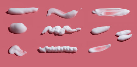 hite soap foam, suds of detergent, cleaning gel or shampoo on pink backdropの写真素材