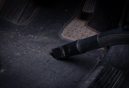 Cleaning automobile salon with vacuum cleaner, closeup. Car wash serviceの写真素材