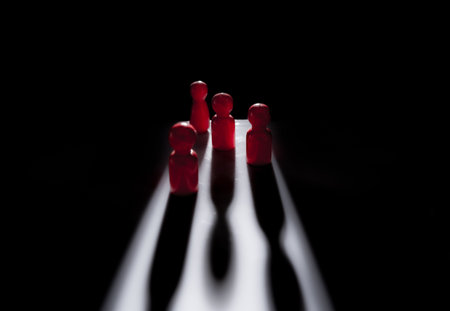 Close up wood person model among people with shodows on dark background, Leadership concept.の写真素材