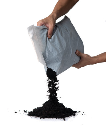 Organic soil from bag poured into pile, isolated on white backgroundの写真素材