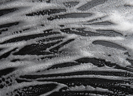 Soap foam, lather  on black, texture and background, top view