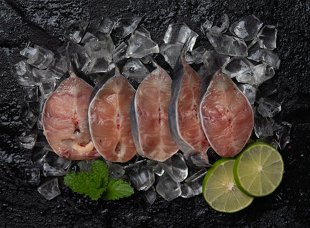 Catfish slices on black stone background, top viewの写真素材