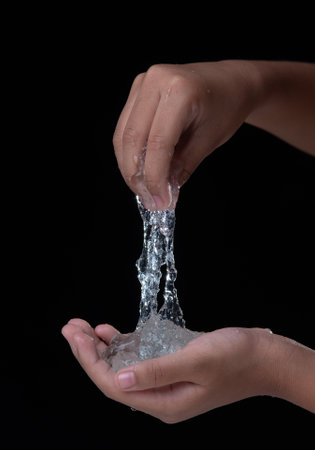Hand stretches blue gel isolated on black background.の写真素材