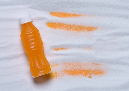Unhealthy food concept ,bottle of sweet drink on sugar,top view