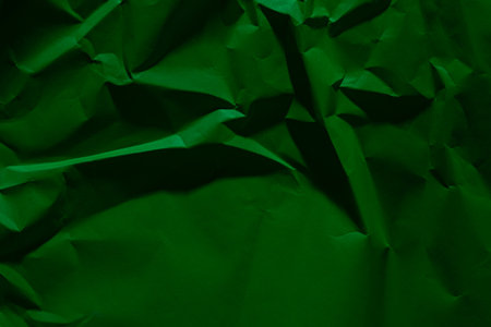 Green old crumpled paper texture in low light background,wrinkled paperの写真素材