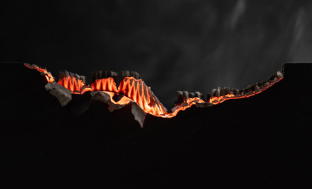 Burning paper on black background,Burnt paper edges.の写真素材