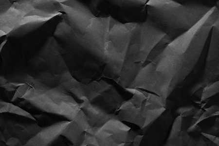 Gray old crumpled paper texture in low light background,wrinkled paperの写真素材