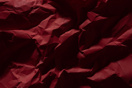 Red old crumpled paper texture in low light background,wrinkled paperの写真素材