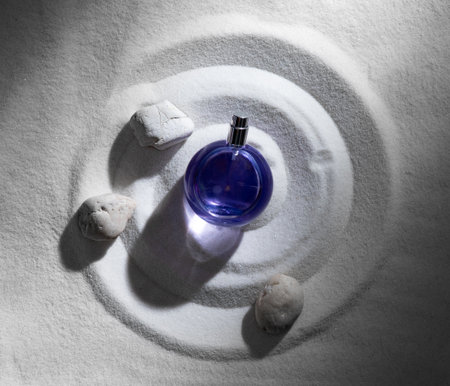 Perfume glass bottle on clean beach sand,Top view, mockup. Concept of beauty and healthの写真素材