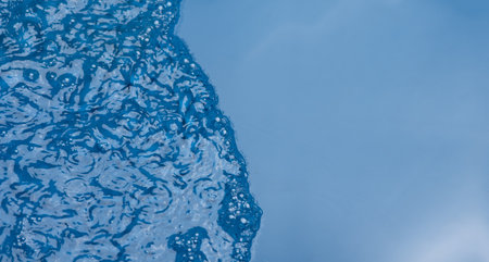 Closeupâ blurâ abstractâ ofâ surfaceâ blueâ water. Abstractâ ofâ surfaceâ blueâ waterâ reflectedâ withâ sunlightâ forâ background.Topâ viewâ of blueâ waterの写真素材
