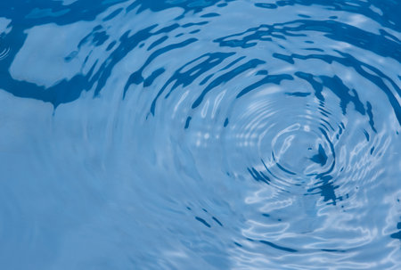 Closeupâ blurâ abstractâ ofâ surfaceâ blueâ water. Abstractâ ofâ surfaceâ blueâ waterâ reflectedâ withâ sunlightâ forâ background.Topâ viewâ of blueâ waterの写真素材
