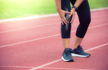 Female runner knee injury and pain,Painful Knee Close-up - Anatomy conceptの写真素材