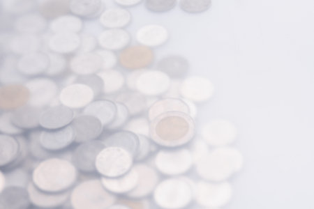 Background pile of different coins on the table,blurred photoの写真素材