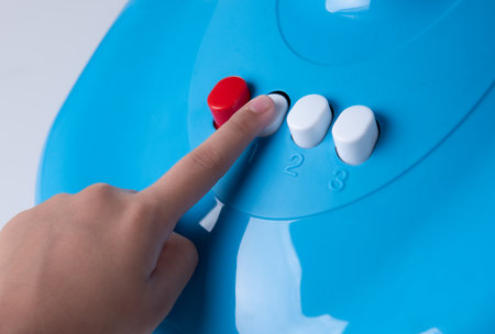 Hand pressing the fan adjustment buttonの写真素材