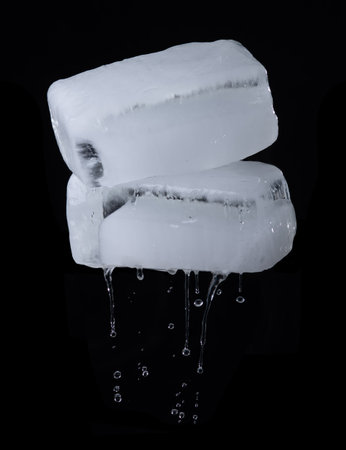 Melting Ice cubes with water drops on black background,rectangular ice blockの写真素材